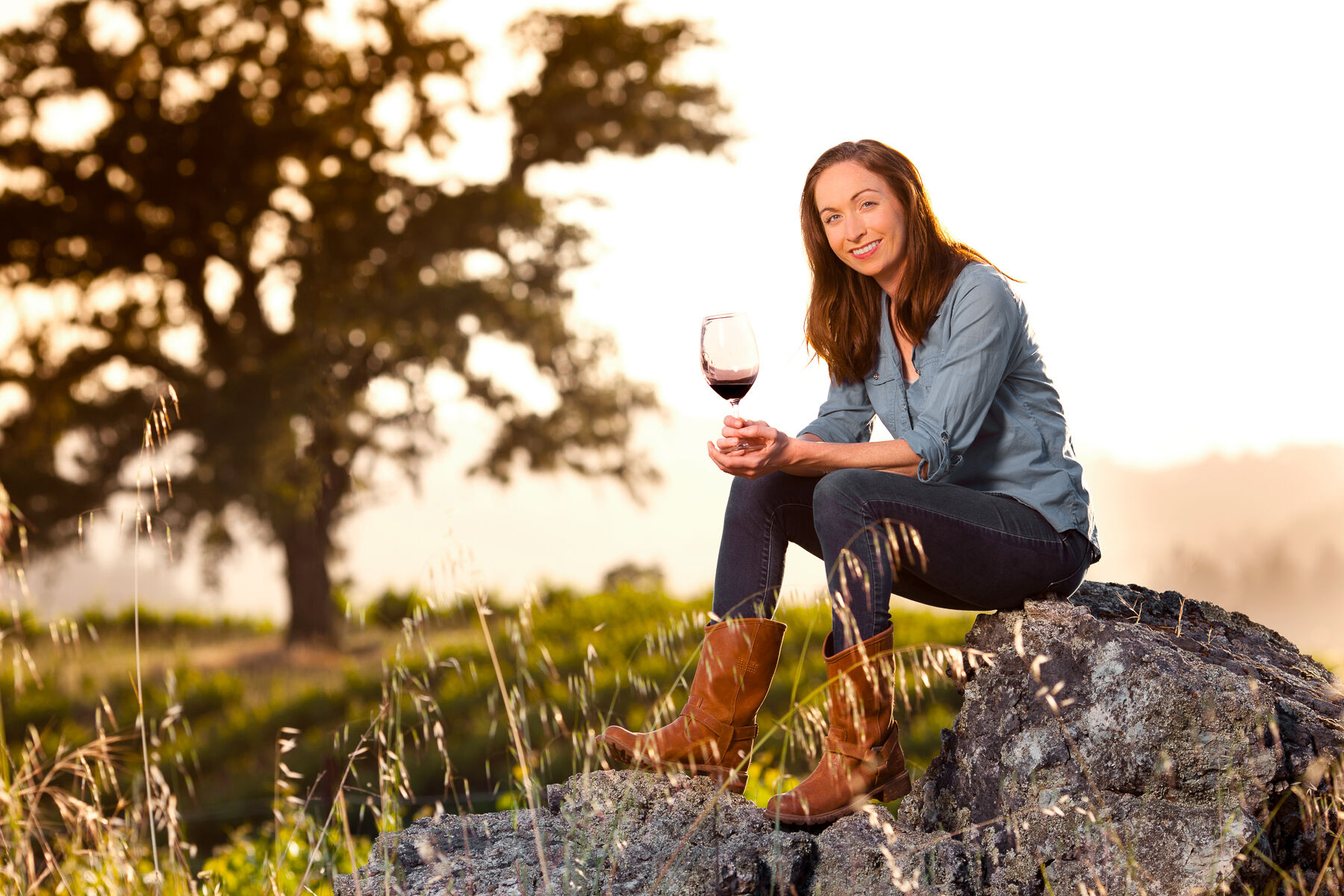 Kristina Shideler in the Vineyard holding a glass of wine